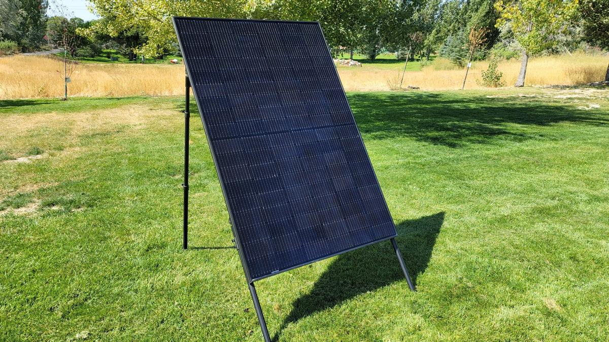 Solar panel standing on a lawn on adjustable stand legs