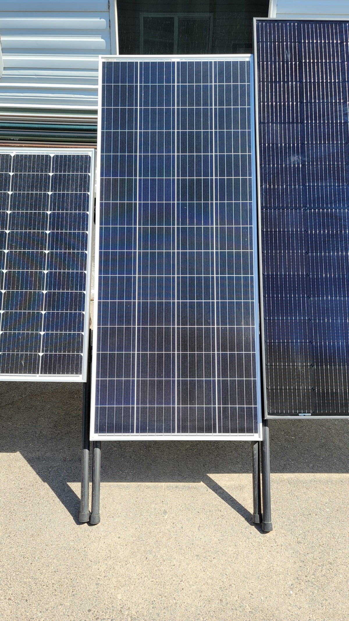 Framed solar panels raised off the ground on upper and lower legs